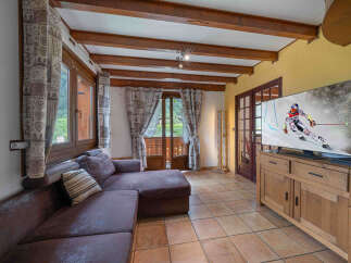 Experience cozy living in this charming room featuring a plush sectional sofa perfect for relaxation.