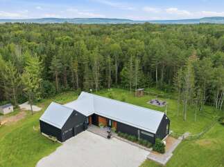 Discover this modern architectural gem nestled amidst a lush forest, offering unparalleled privacy and tranquility.