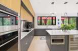 Experience modern luxury in this stunning kitchen, featuring sleek Wolf appliances and custom wood cabinetry.