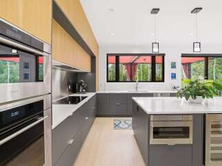 Experience modern luxury in this stunning kitchen, featuring sleek Wolf appliances and custom wood cabinetry.