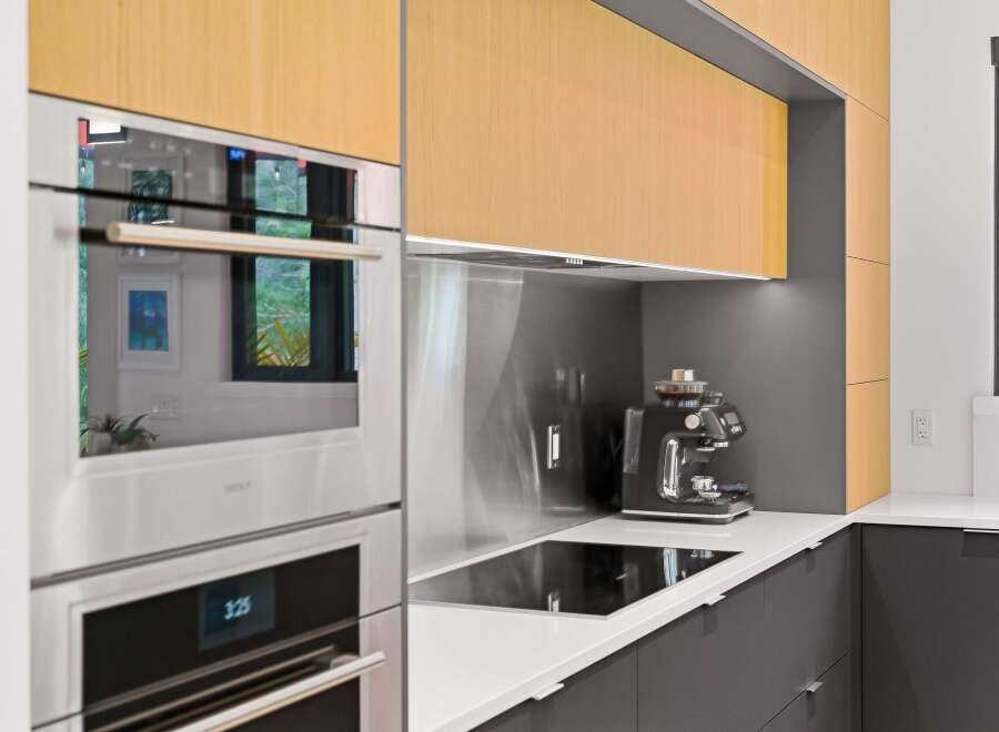 Experience modern luxury in this stunning kitchen, featuring sleek Wolf appliances and a built-in espresso machine for your morning routine.