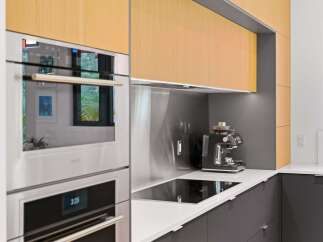 Experience modern luxury in this stunning kitchen, featuring sleek Wolf appliances and a built-in espresso machine for your morning routine.