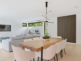 Experience modern living in this open-concept dining and living area, featuring a stunning live-edge dining table and plush seating.