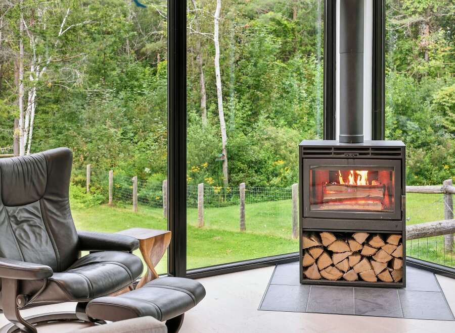 Experience cozy living in this stunning home featuring a modern wood-burning fireplace, perfect for warming up on chilly evenings.