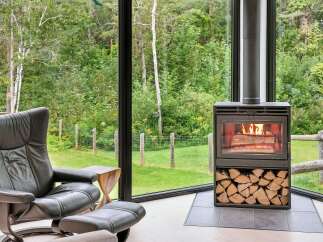 Experience cozy living in this stunning home featuring a modern wood-burning fireplace, perfect for warming up on chilly evenings.