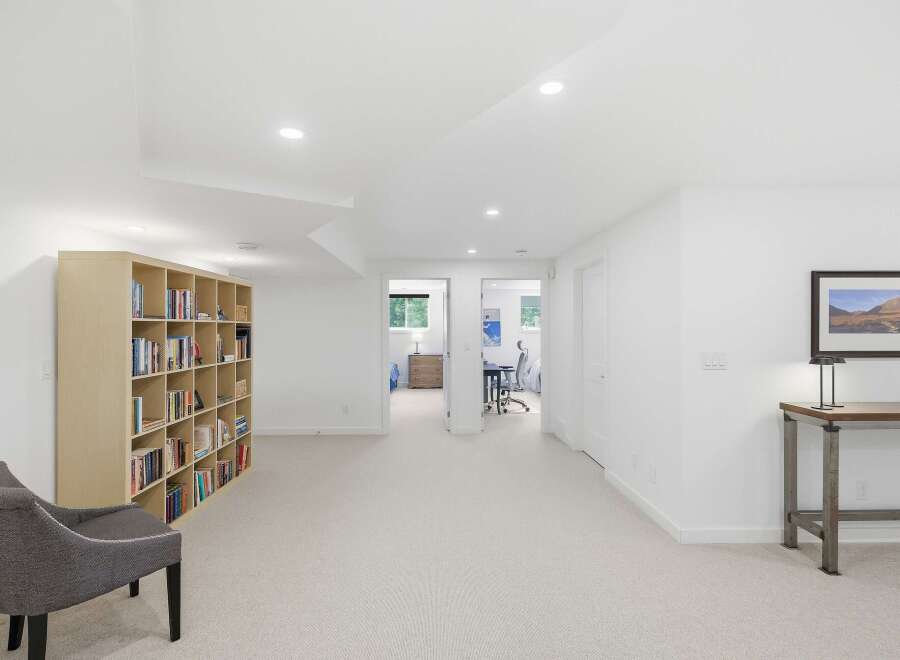 This spacious basement features a large, built-in bookshelf perfect for displaying your favorite reads.