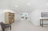 This spacious basement features a large, built-in bookshelf perfect for displaying your favorite reads.
