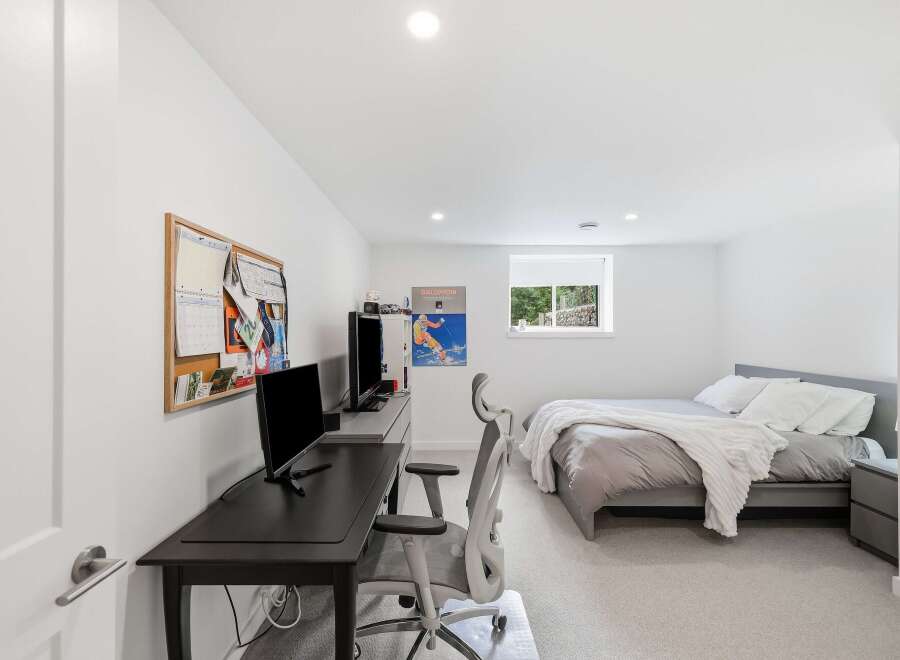 This modern bedroom offers a dedicated workspace with a sleek desk and ergonomic chair, perfect for productivity.