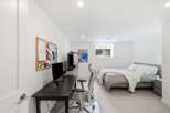 This modern bedroom offers a dedicated workspace with a sleek desk and ergonomic chair, perfect for productivity.
