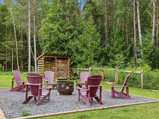 Enjoy the outdoors with this charming fire pit area, perfect for gathering with friends and family.
