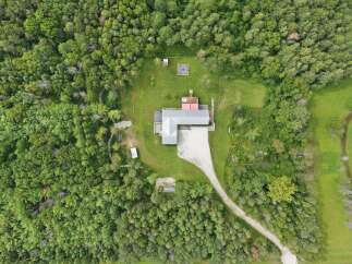 Discover this secluded property nestled amongst lush greenery, offering a private retreat.