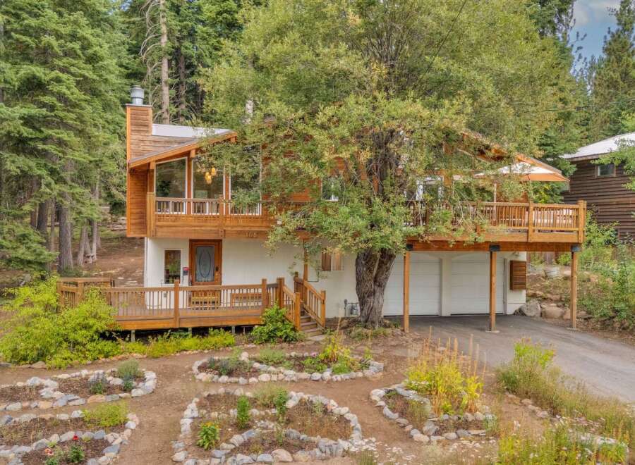 Nestled amidst towering trees, this charming home offers a serene mountain retreat.
