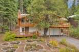 Nestled amidst towering trees, this charming home offers a serene mountain retreat.
