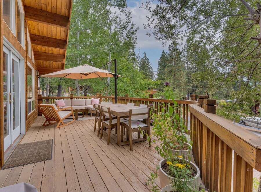 Enjoy outdoor living on this spacious wooden deck, perfect for entertaining or relaxing amidst nature.