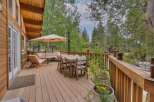 Enjoy outdoor living on this spacious wooden deck, perfect for entertaining or relaxing amidst nature.