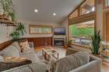 Experience cozy living in this inviting living room, featuring a warm fireplace and a large TV perfect for movie nights.