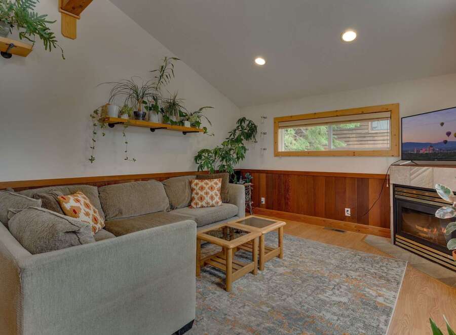 Cozy living room featuring a comfortable sectional sofa adorned with decorative pillows, perfect for relaxing evenings.