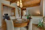 This inviting dining area features a round wooden table with a slate inlay, perfect for family meals.