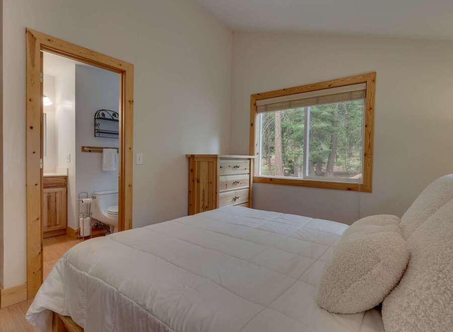 This charming bedroom offers a cozy retreat with a comfortable bed and a convenient en-suite bathroom.