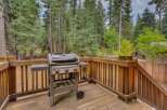 Enjoy outdoor living with this spacious deck, perfect for entertaining or relaxing amidst a serene forest setting.