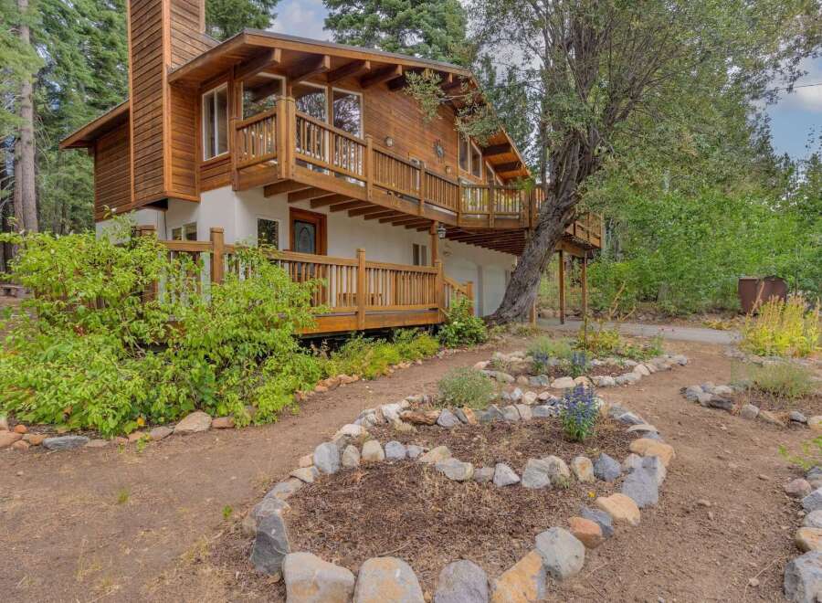 Nestled amidst towering trees, this charming wooden home offers a serene retreat.