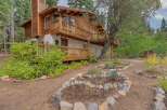 Nestled amidst towering trees, this charming wooden home offers a serene retreat.