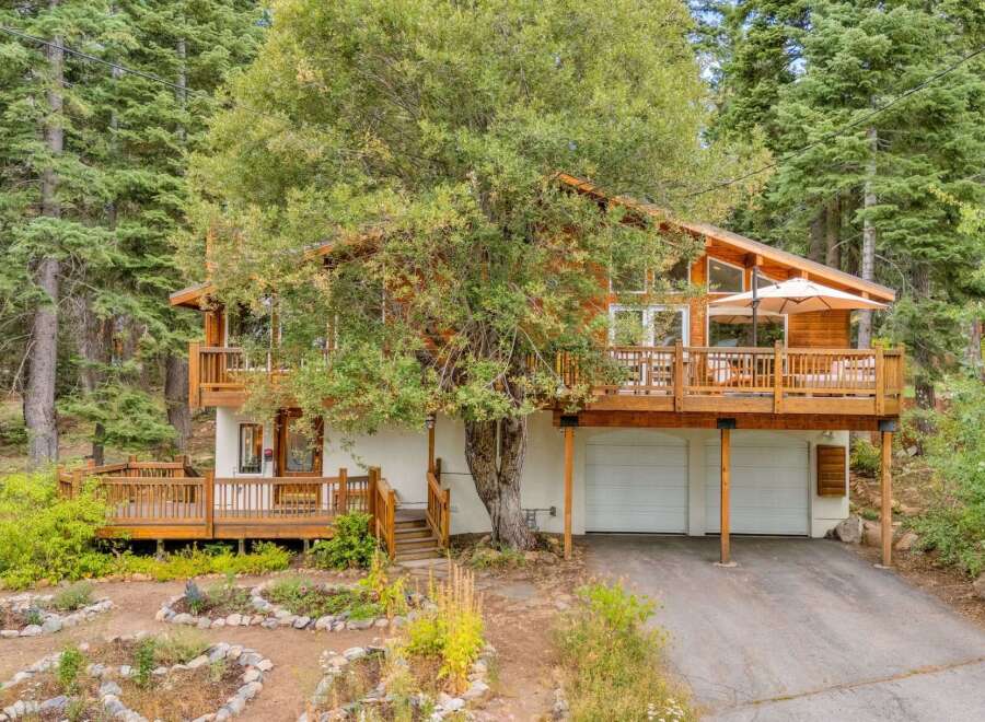 Nestled amongst tall trees, this charming home offers a serene mountain retreat.
