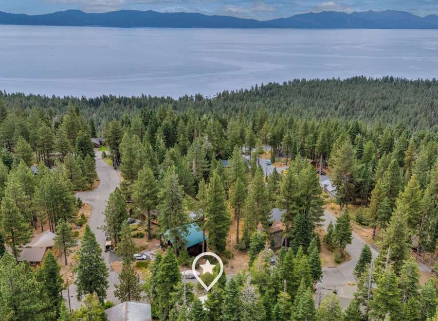 Nestled amidst a dense forest with a stunning lake view, this property offers a serene retreat.
