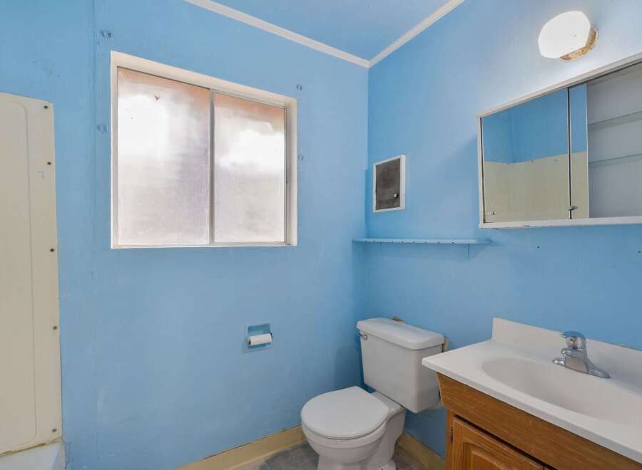 This bathroom features a bright blue color scheme, creating a cheerful atmosphere.