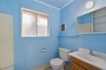This bathroom features a bright blue color scheme, creating a cheerful atmosphere.