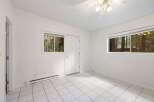 Discover a bright and airy room featuring crisp white walls and large windows that flood the space with natural light.