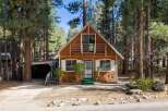 Nestled among tall pine trees, this charming wooden cabin offers a serene mountain retreat.