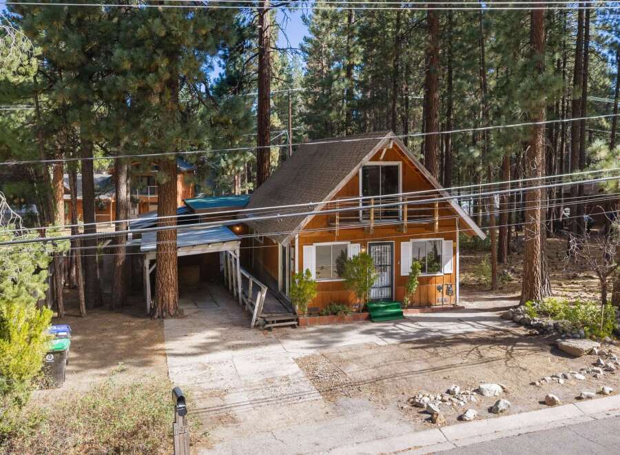 Nestled amongst tall pine trees, this charming cabin offers a serene mountain retreat.