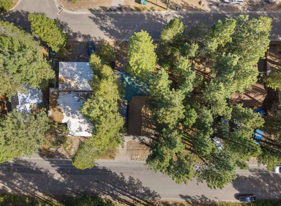 Discover this charming property nestled among mature pine trees, offering a serene and private setting.