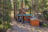 Nestled among tall pine trees, this charming cabin offers a serene mountain retreat.