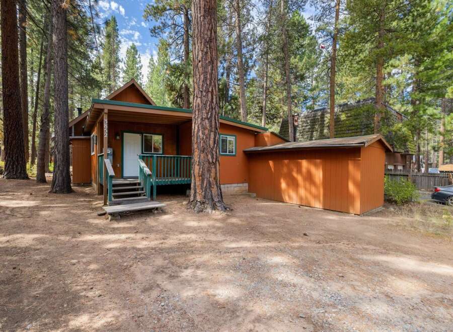 Nestled among tall pine trees, this charming cabin offers a serene retreat.