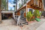 Discover this charming cabin nestled among tall pine trees, offering a rustic retreat.