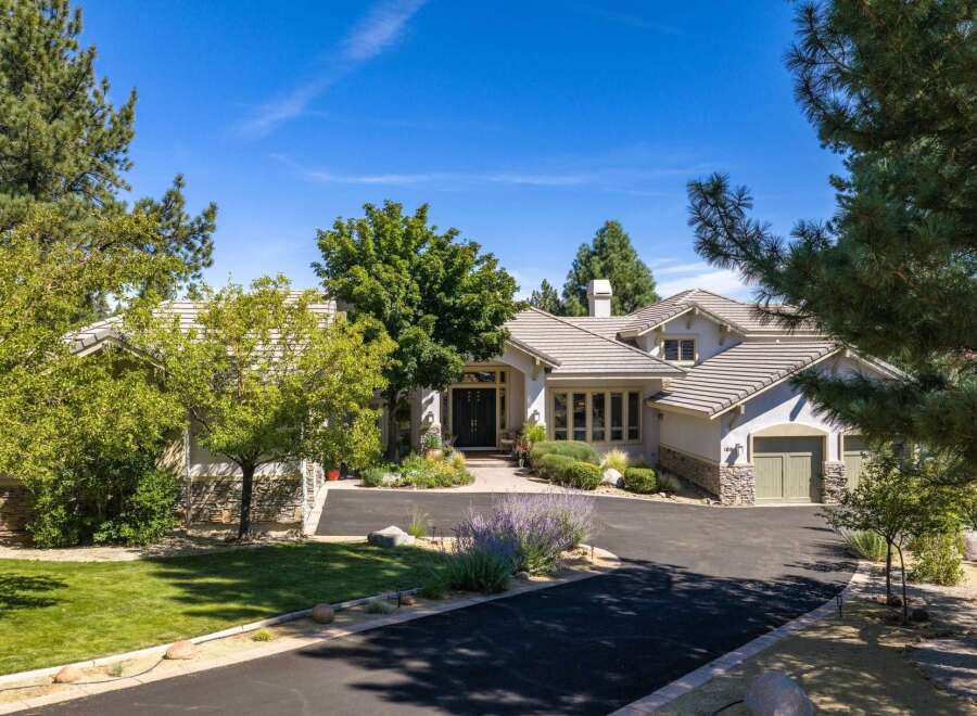 Discover this stunning residence featuring a grand entrance with double doors, leading into a beautifully landscaped yard.