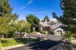 Discover this stunning residence featuring a grand entrance with double doors, leading into a beautifully landscaped yard.