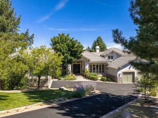 Discover this stunning residence featuring a grand entrance with double doors, leading into a beautifully landscaped yard.