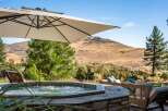 Relax and unwind in this luxurious outdoor oasis featuring a bubbling hot tub perfect for soaking under the sun.