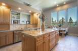 Experience luxury living in this stunning kitchen, featuring a spacious granite island perfect for entertaining and meal prep.