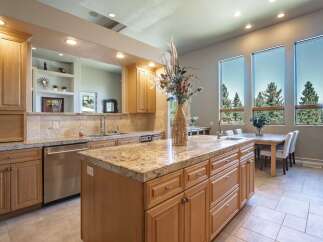 Experience luxury living in this stunning kitchen, featuring a spacious granite island perfect for entertaining and meal prep.