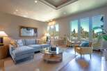 Experience luxury living in this stunning living room, featuring a spacious sectional sofa and elegant armchairs perfect for relaxation.