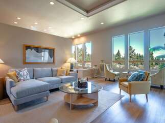 Experience luxury living in this stunning living room, featuring a spacious sectional sofa and elegant armchairs perfect for relaxation.