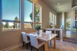 Experience breathtaking views from this dining area, featuring expansive windows that showcase the natural landscape.