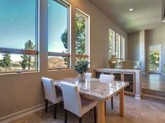 Experience breathtaking views from this dining area, featuring expansive windows that showcase the natural landscape.