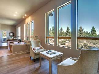 Experience breathtaking mountain views from this stunning living area, featuring expansive windows that flood the space with natural light.