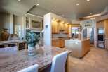 Experience luxury living in this stunning kitchen and dining area, featuring a spacious granite-topped island perfect for entertaining.