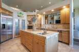 Experience luxury in this spacious kitchen featuring a large granite island with a built-in sink, perfect for meal prep and entertaining.
